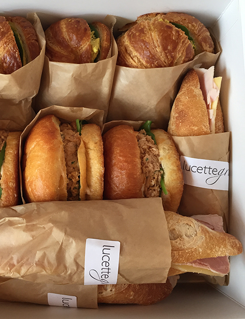overhead view of catered box of assorted sandwiches