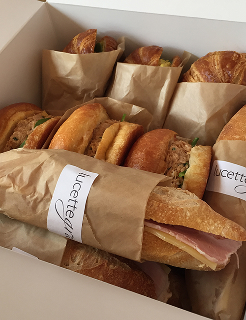 catered box of an assortment of sandwiches individually wrapped