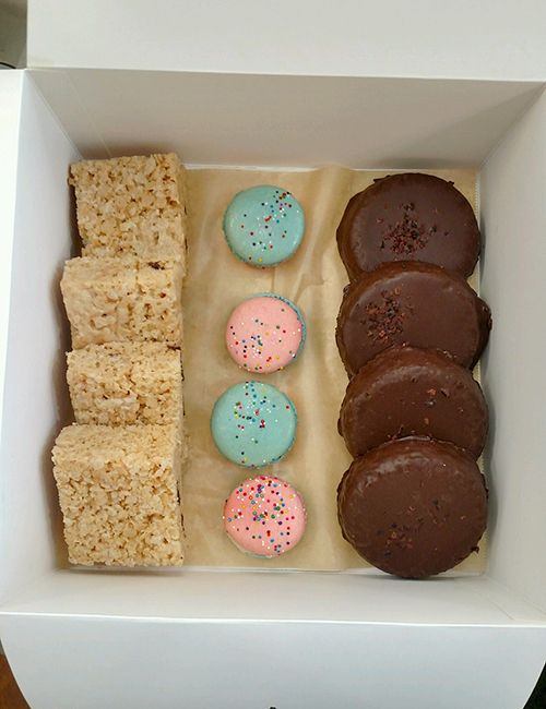 catering box of gluten free treats includes rice krispy treat, birthday cake macarons, and coconut frangipane