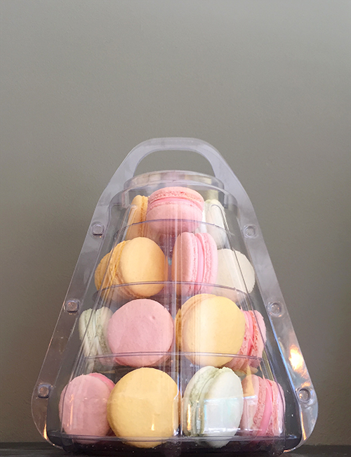small macaron tower in a portable plastic case